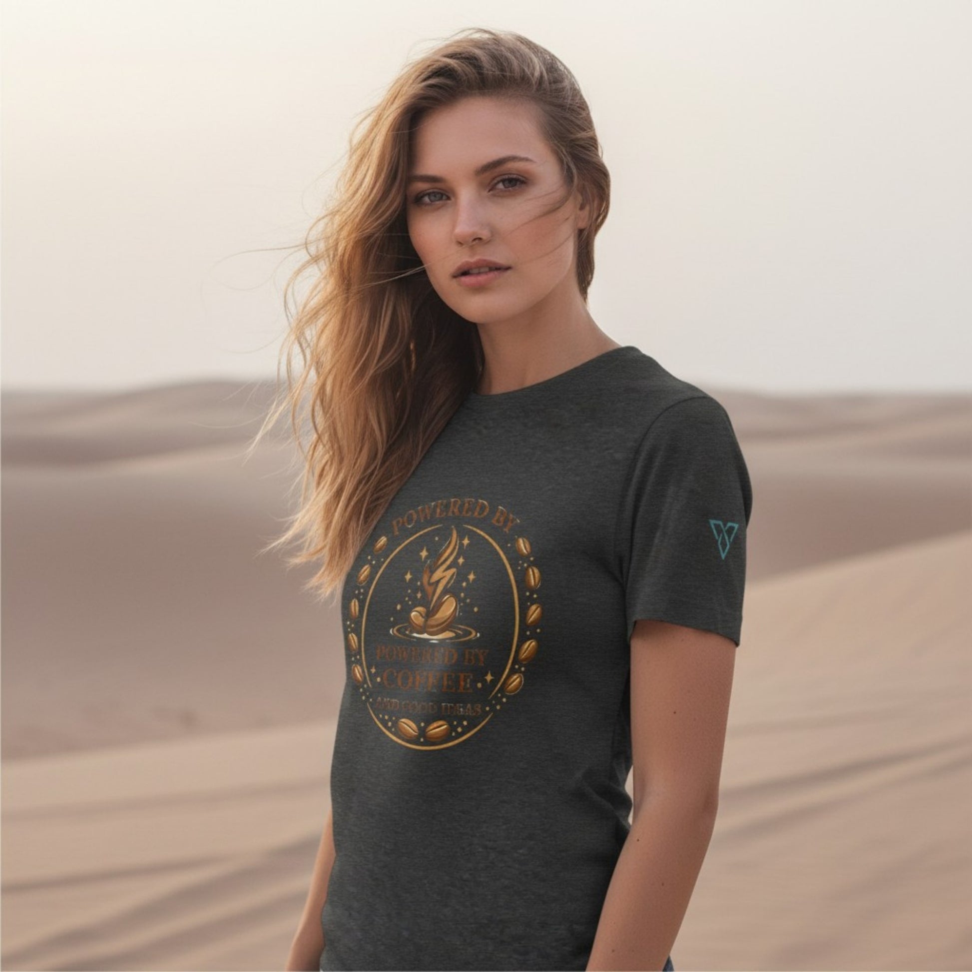 woman wearing dark grey t-shirt with Powered by Coffee design in desert setting, lifestyle image, HorizonVibe